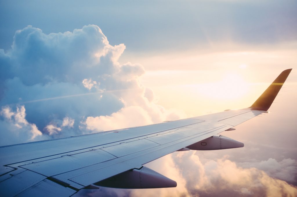 airplane wing in front of evening sky