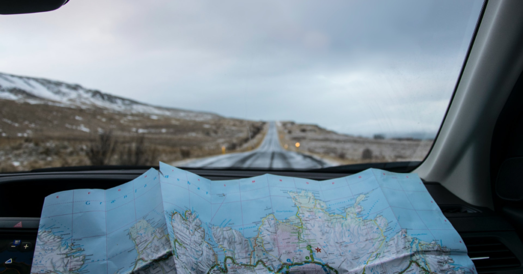 road trip in iceland with map in the car. should show that papermap is not mandatory because of the best itinerary and travel planner apps which are presented in this article