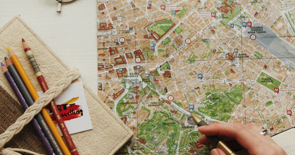 map of rome and some pencils next to the map. thos picture should decorate the text about the best itinerary and travel planner apps