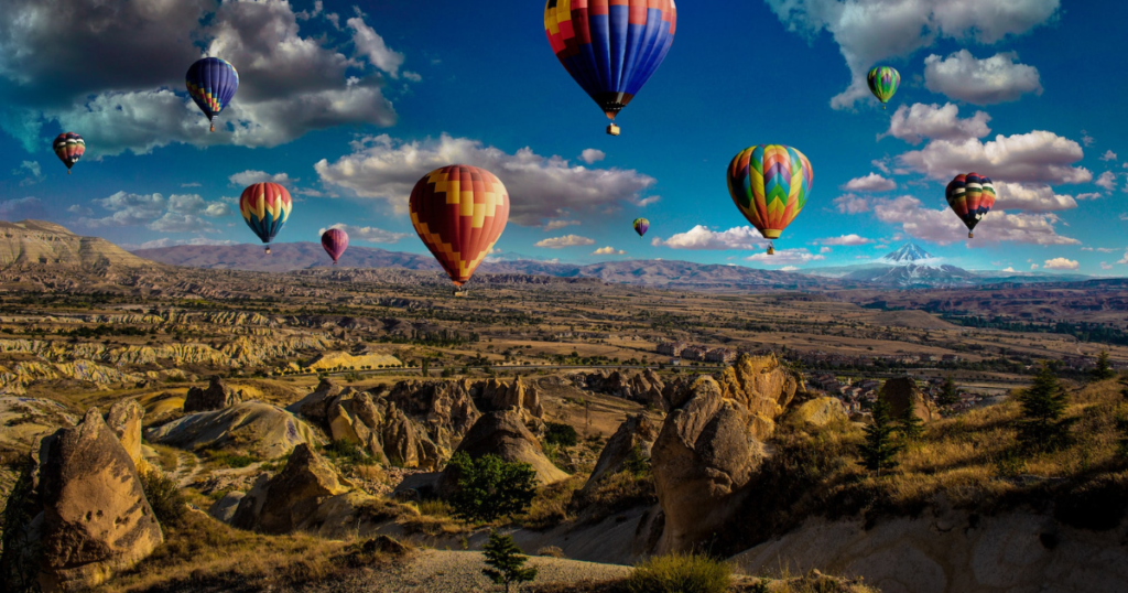 hot air balloons flying over breathtaking landscape. picture visualize the idea of a hot air balloon ride as a valentinesday gift for traveler