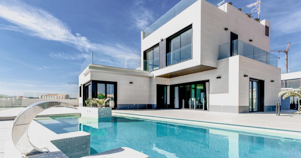 luxury house sitting house with pool and blue sky 