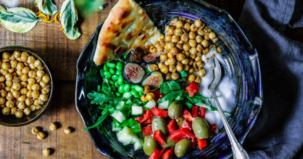oriental vegan meal with olives, beans, fig and chickpeas in a bowl
This can be something to eat during vegan traveling