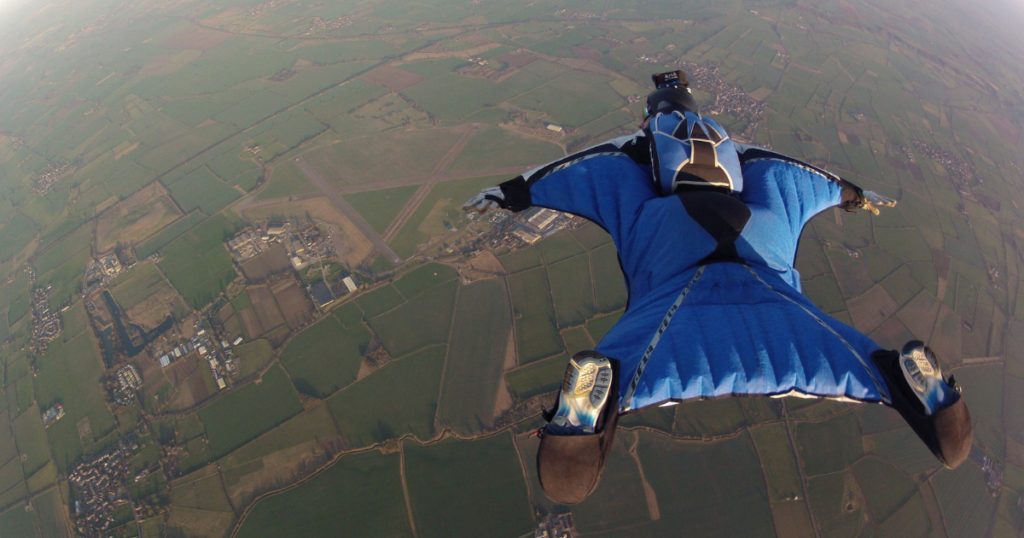 Flying with a wingsuit as extreme sports travel activity