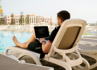 Best digital nomad jobs. man with laptop at the swimming pool