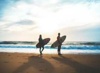 Ultimate Best Friend Travel Bucket List. Friends with surf boards at the beach