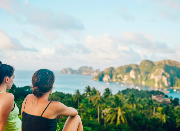 friends on a trip in Thailand sitting with nice view over a beautiful bay